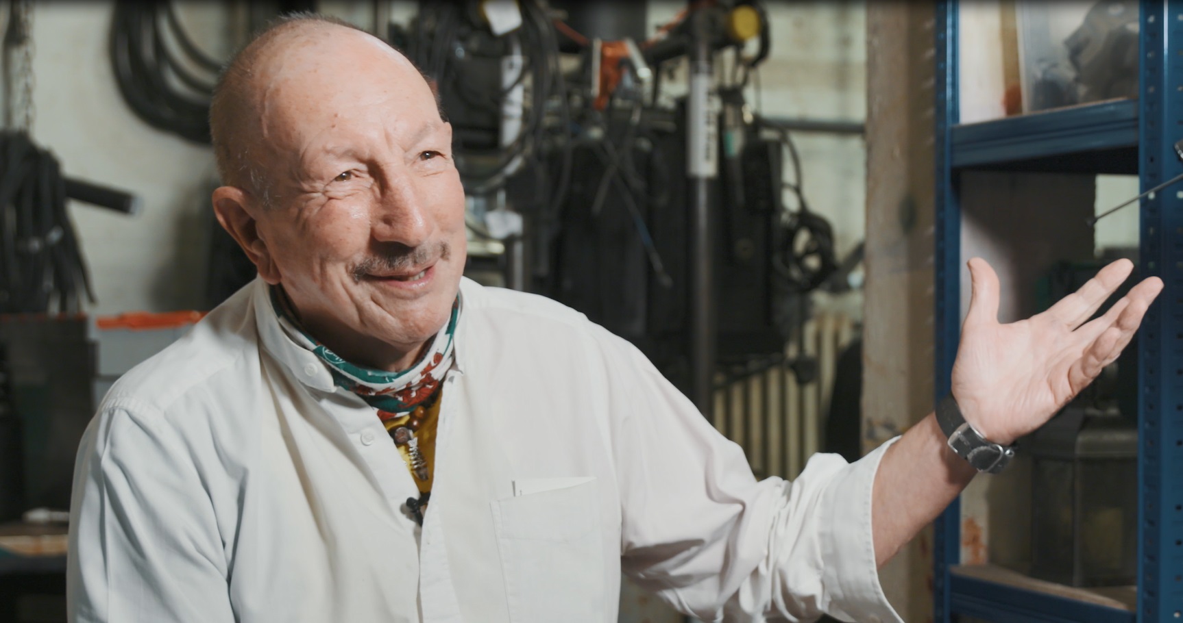 Chris Jones smiles and holds out his hand as he's interviewed backstage at The Old Vic