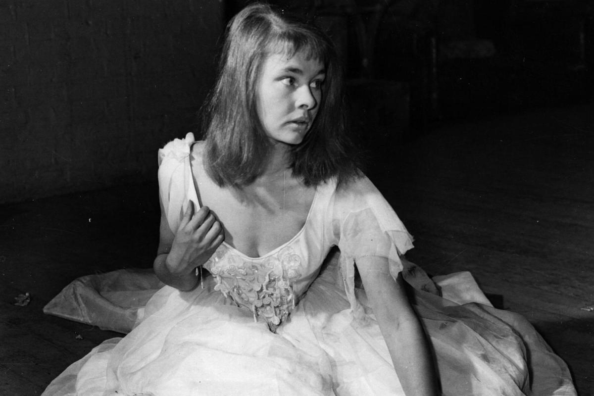 Judi Dench sits on the floor in a white flowing dress